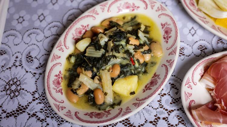 Italian-style entree on a white lace tablecloth. 