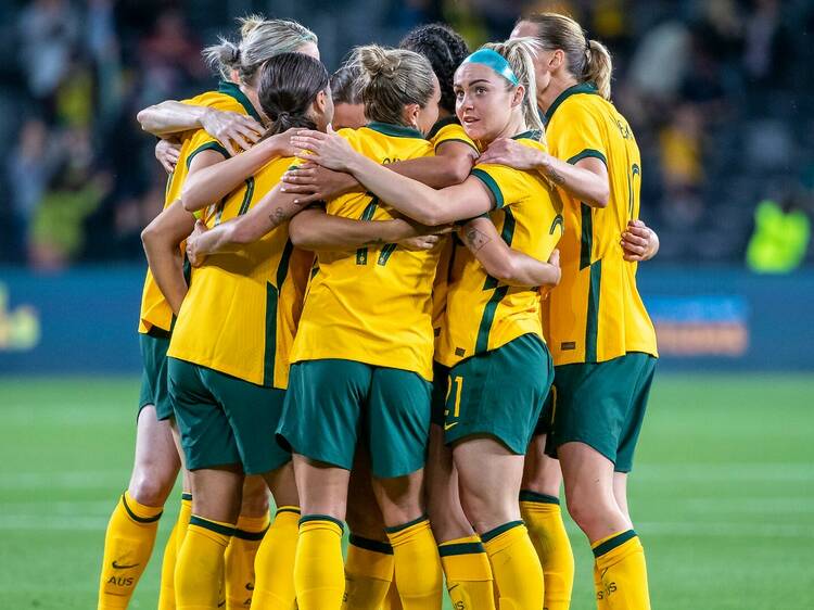 The Matildas in a huddle on the field