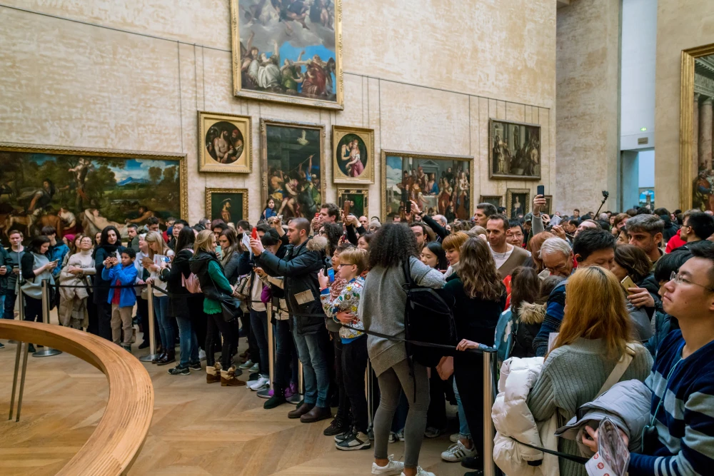 Visitors take photo of Leonardo da Vinci's Mona Lisa at the Louvre Museum