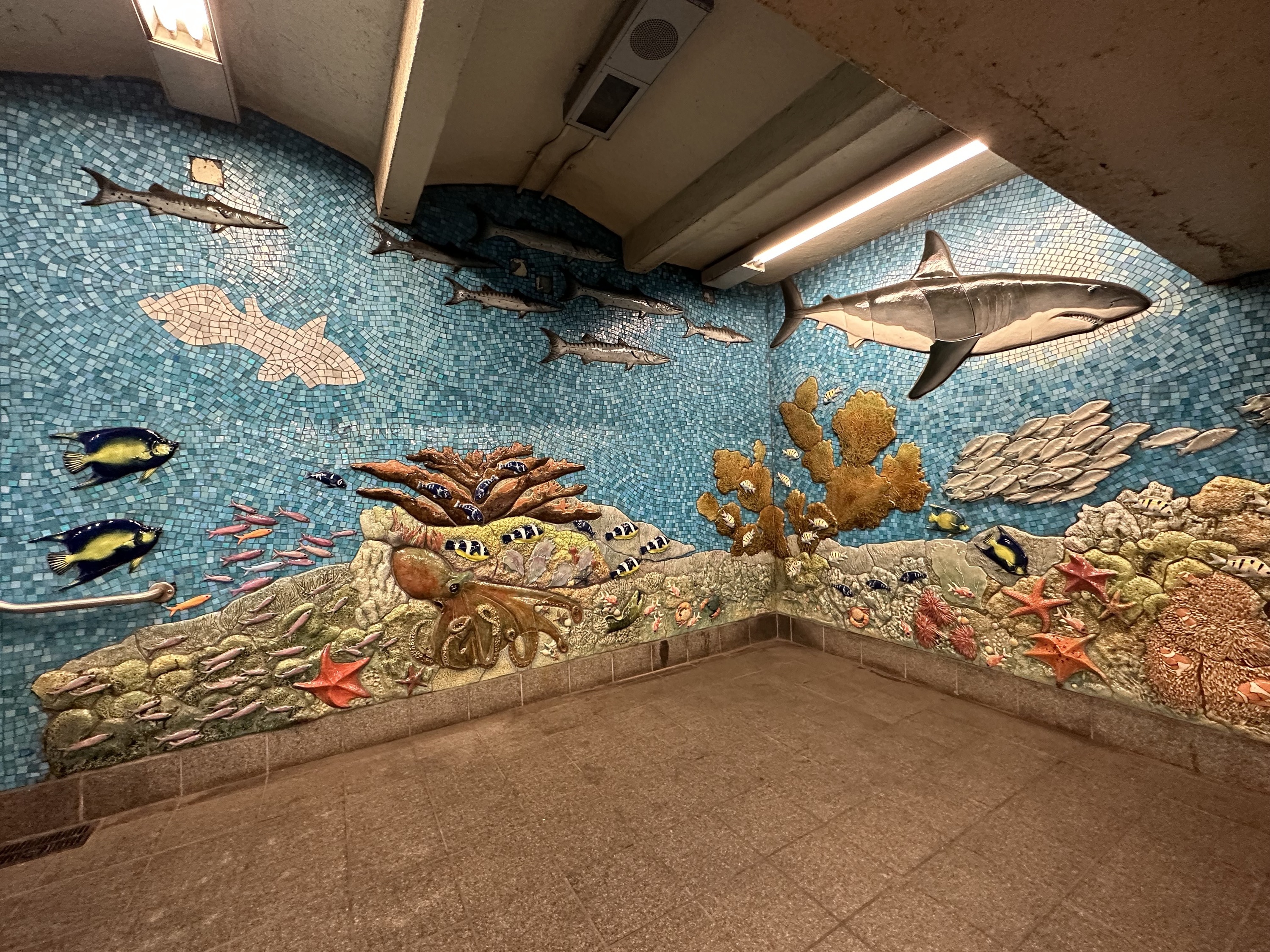 A mosaic with fish and sharks in the subway station near AMNH.