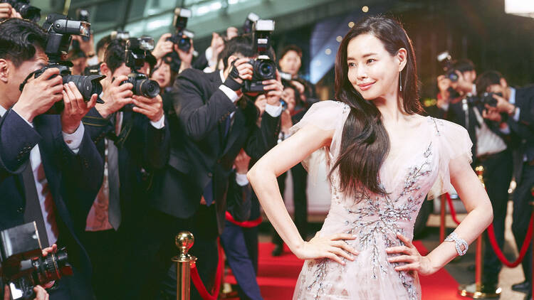 An actress poses on a red carpet.