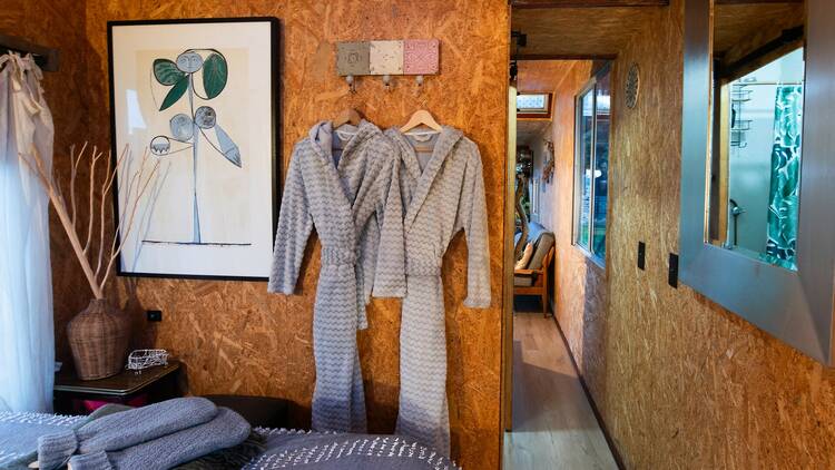 Two robes hanging on the wall in a cabin at Wattle Bank Farm
