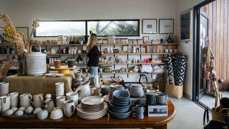 A woman looks at products in a homewares store