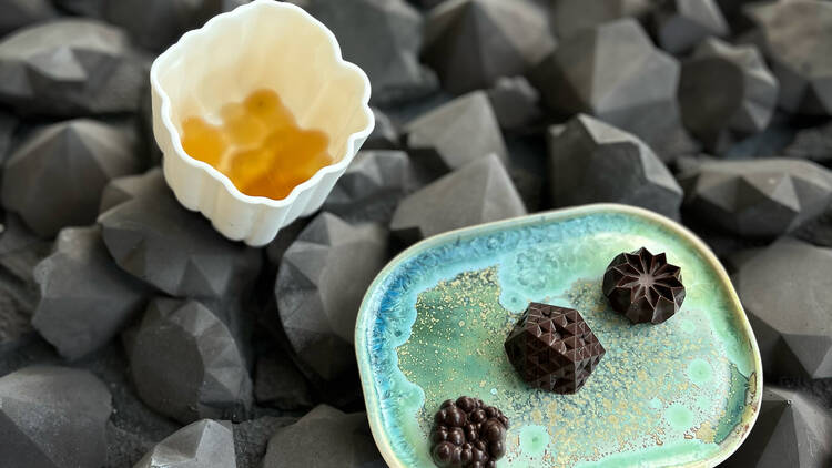 3D-printed chocolates plated up on a geometric surface. 