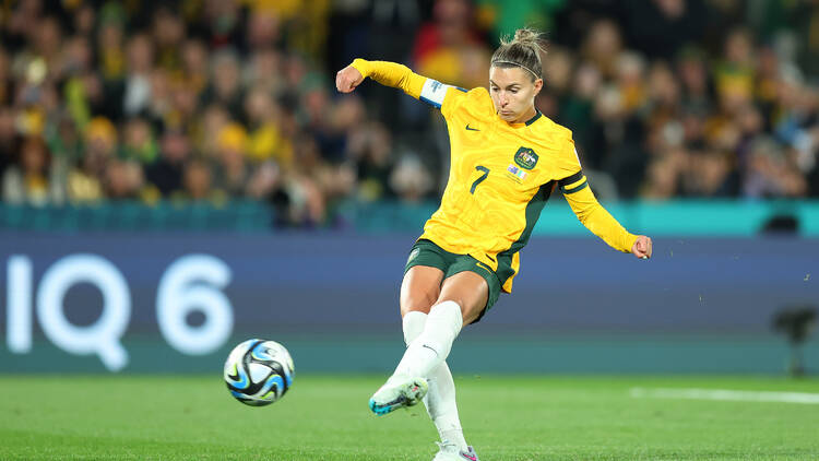 A female soccer player kicking the ball