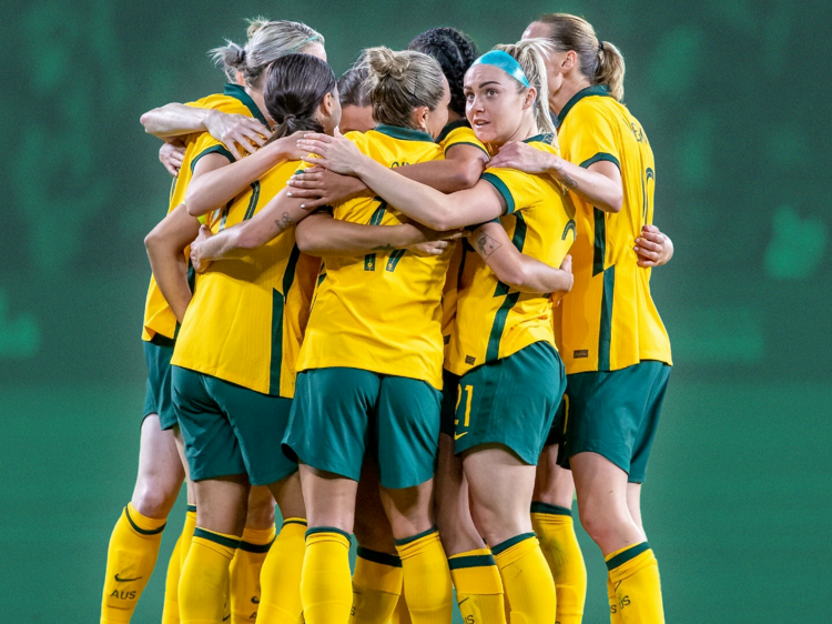 The Matildas women's football team in a huddle