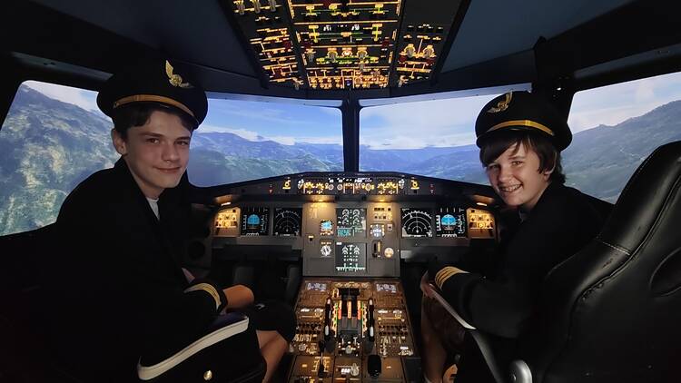 Two boys in a flight simulator 