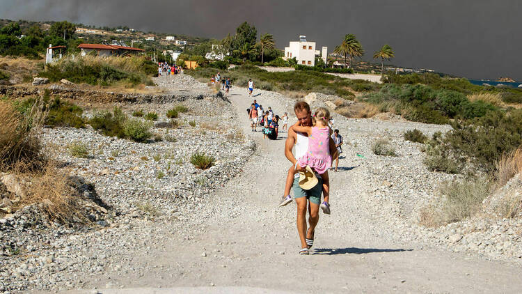 Tourists are evacuated as huge wildfire rages across Greece's Rhodes island on July 22, 2023