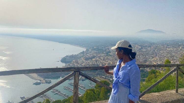 Woman looks out over the sea in Sicily