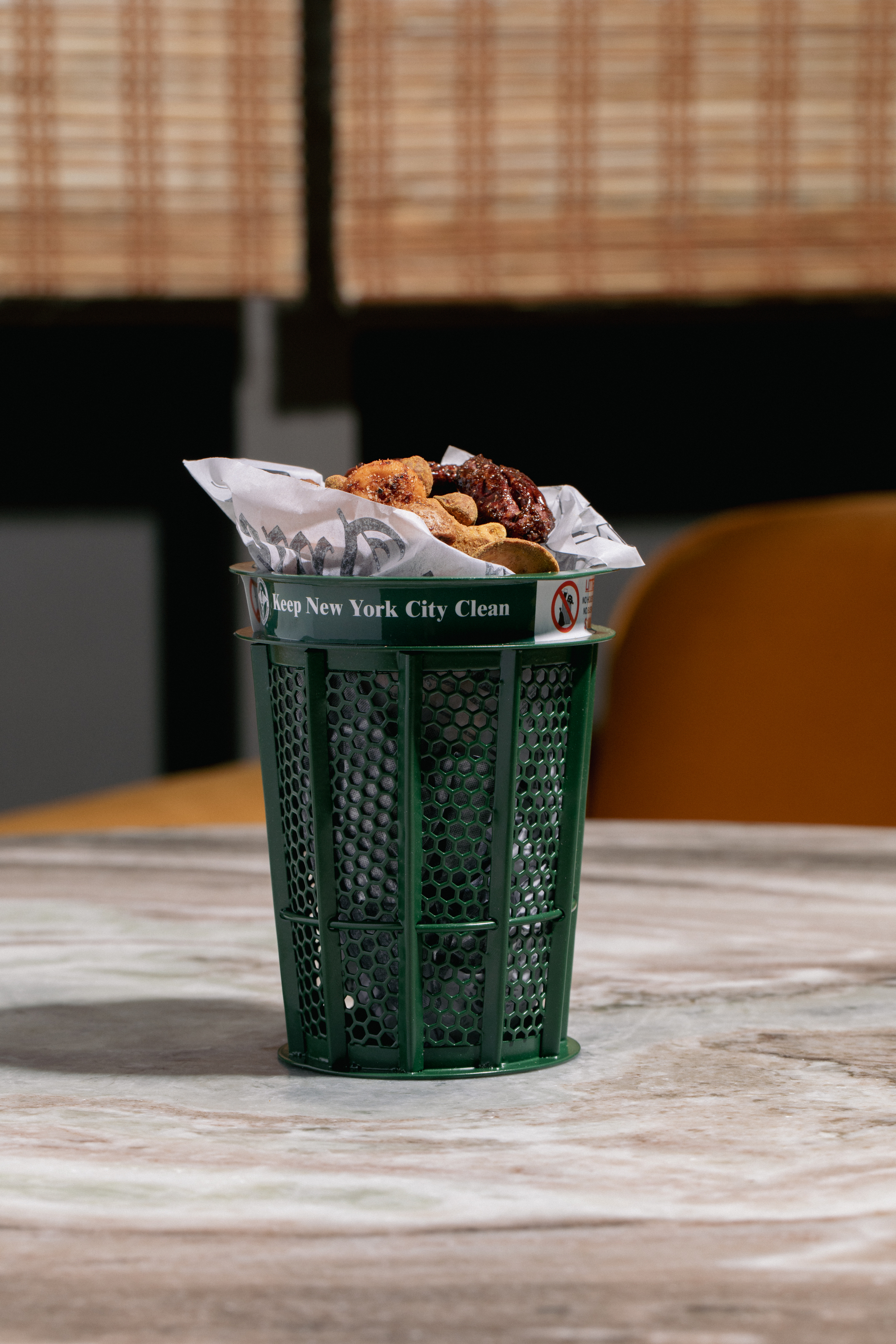 Eat nuts out of a mini NYC trash can at this new rooftop bar