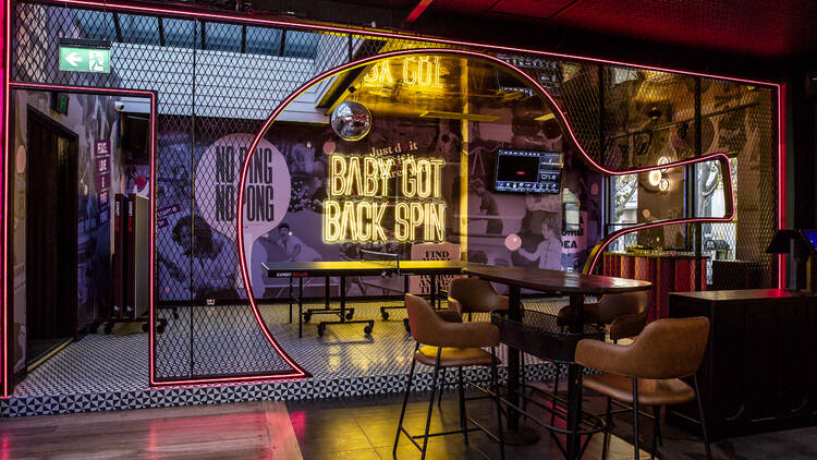 Neon-lit interior of bar space.