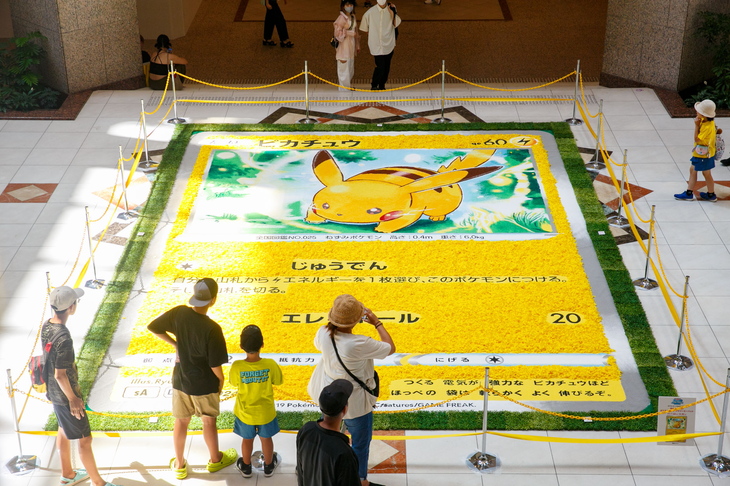 A boy, together with Pikachu(left), a Pokemon creature and Yomiuri Giants  team's mascot Giabbit, stands for a souvnir picture at Tokyo Dome before  the baseball game against Yokohama BayStars, on Thursday, Sept.