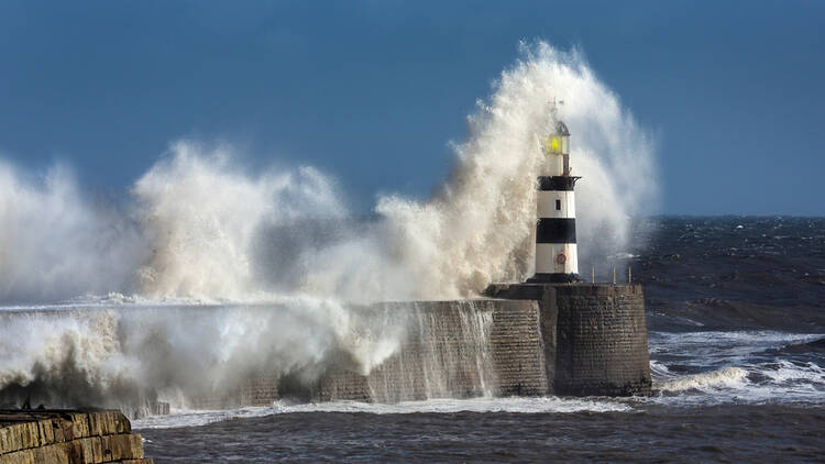 Waves crashing against Seaham lighthouse in England
