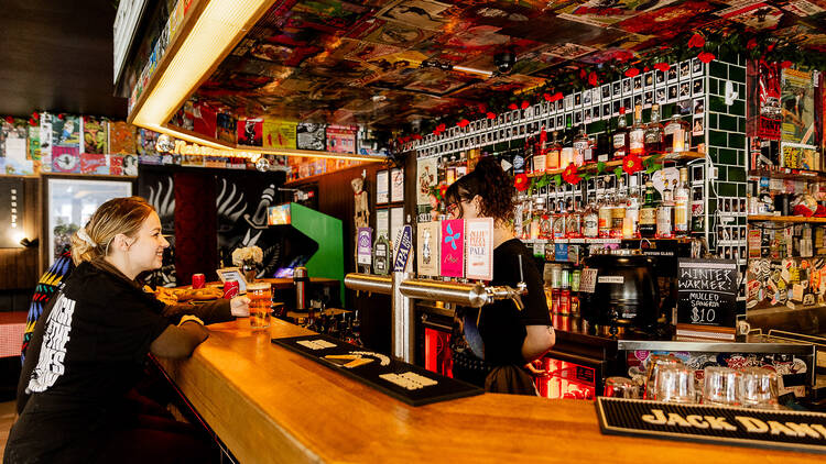 Woman at a bar being served.