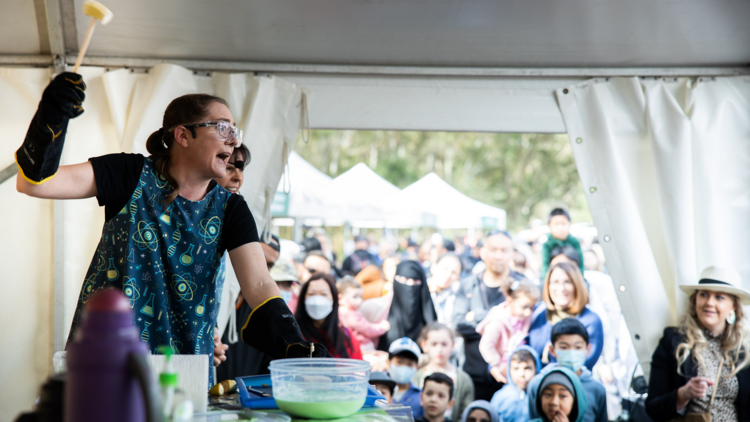 A scientist doing an experiment in front of a crowd