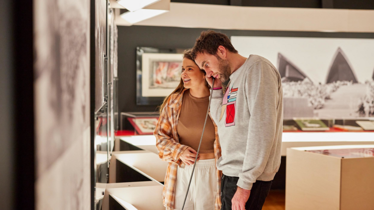 A couple exploring a Sydney Opera House museum exhibition