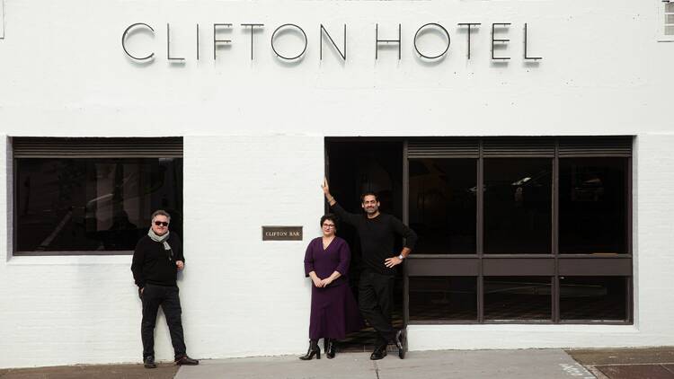 Hospitality crew standing in front of the newly restored Clifton Hotel.