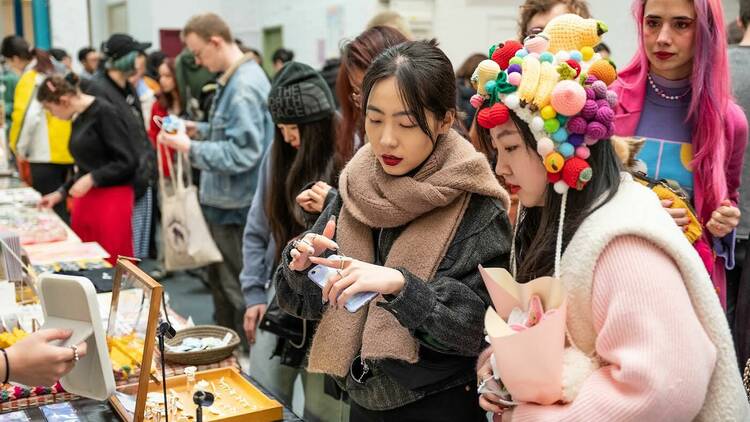 Customers browsing stall at DIY Art Market