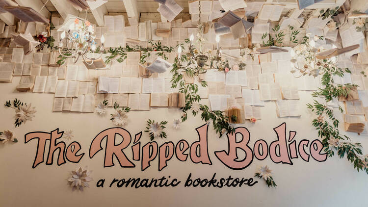 A sign reading "The Ripped Bodice" in pink lettering.