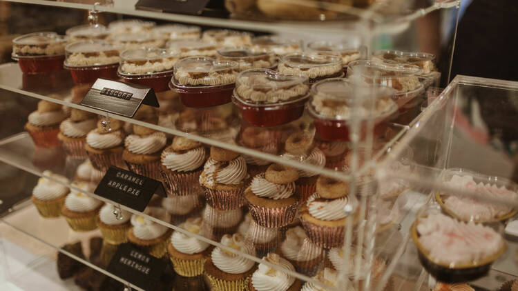 Rows of mini cupcakes and sweet treats on display. 
