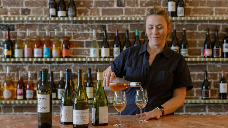 Owner Amelia Birch pouring wine