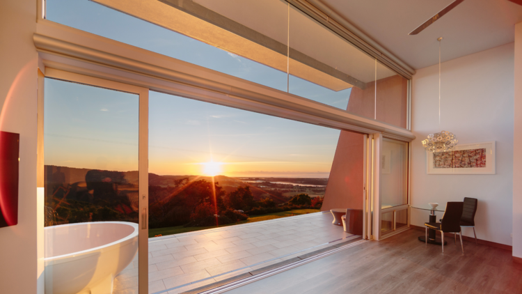 Interior of hotel room at sunrise with outdoor bath