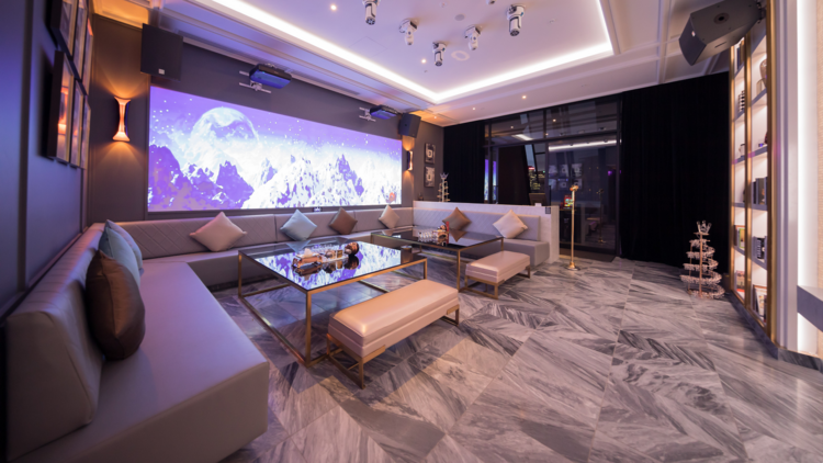 A luxe karaoke room with leather couches