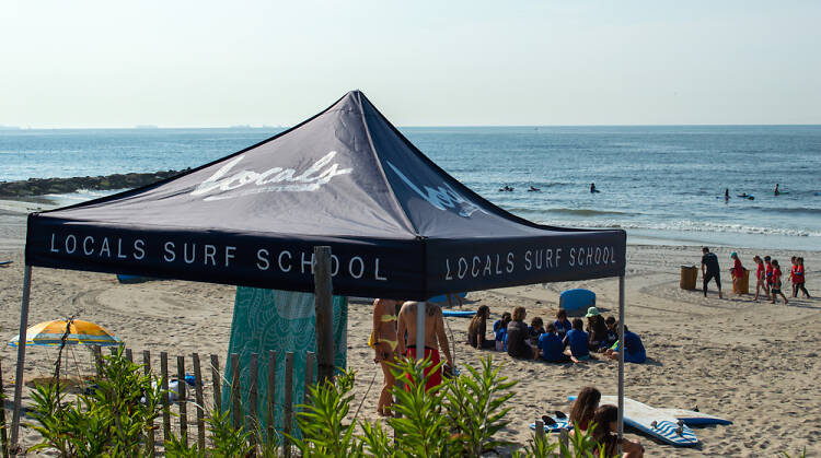 Rockaway Beach in Queens with local surf school tent on the sand