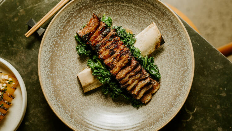 A plate of beef short ribs with kale.