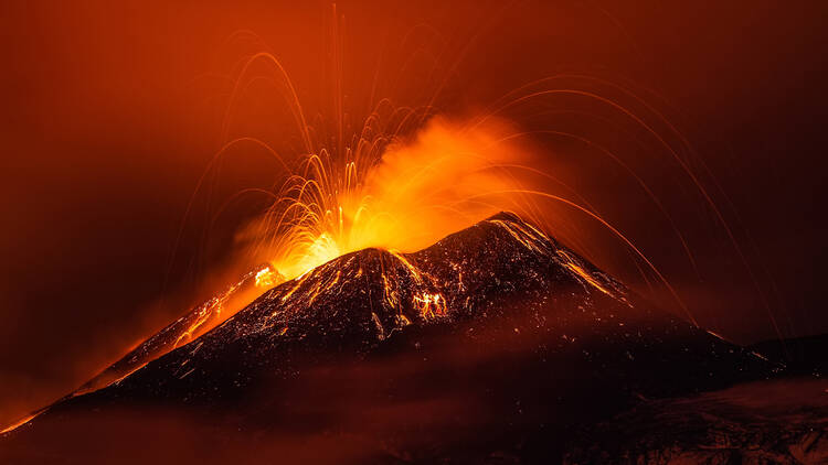 Mount Etna erupting at night