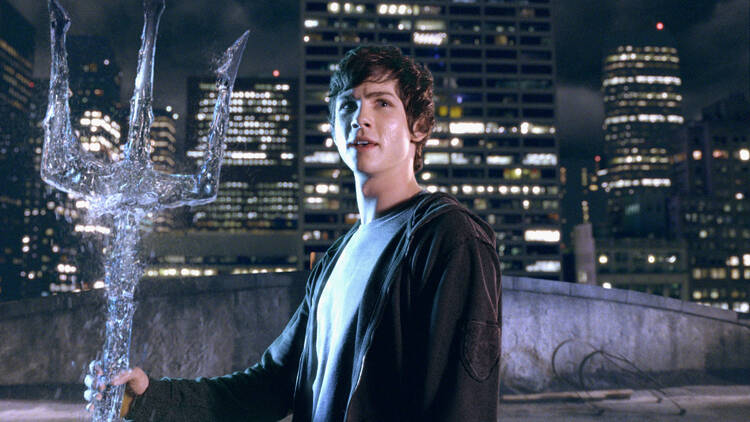 Percy Jackson (Logan Lerman) stands triumphant with the trident belonging to his father, the Greek god Poseidon.
