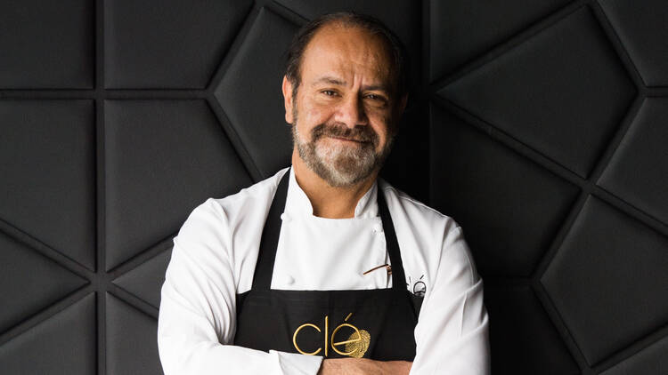 Chef Greg Malouf with his arms crossed and smiling