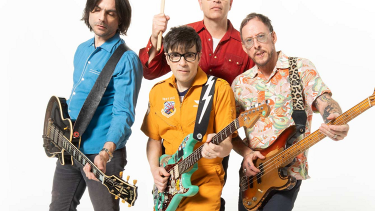 picture of the band weezer playing electric guitars