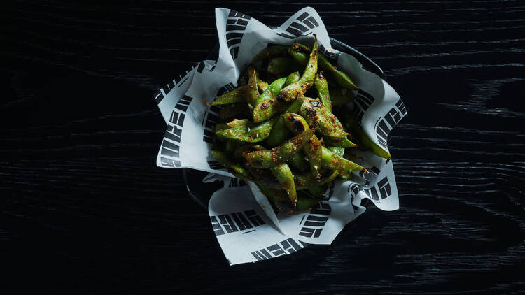 Spiced edamame in a paper-lined bowl.