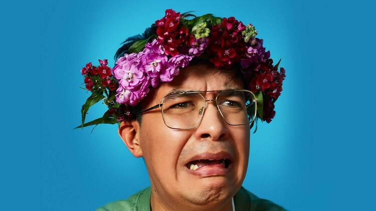 picture of comedian phil wang looking stressed wearing a floral crown