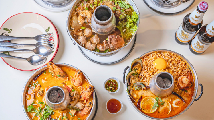 Three hot pots on a white table