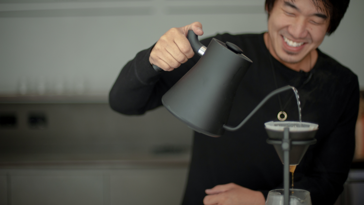 A barista pouring a filter coffee