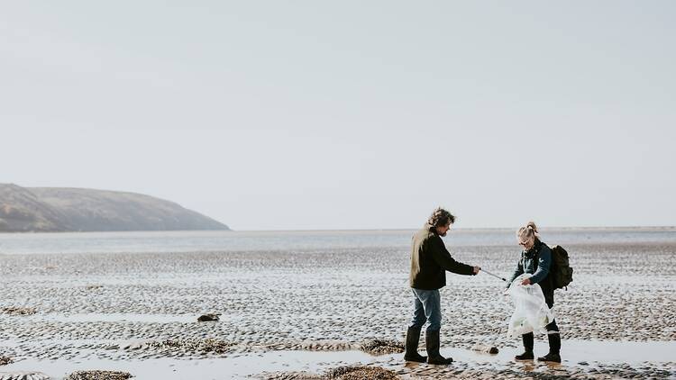 Volunteers picking up litter off a beach in the UK