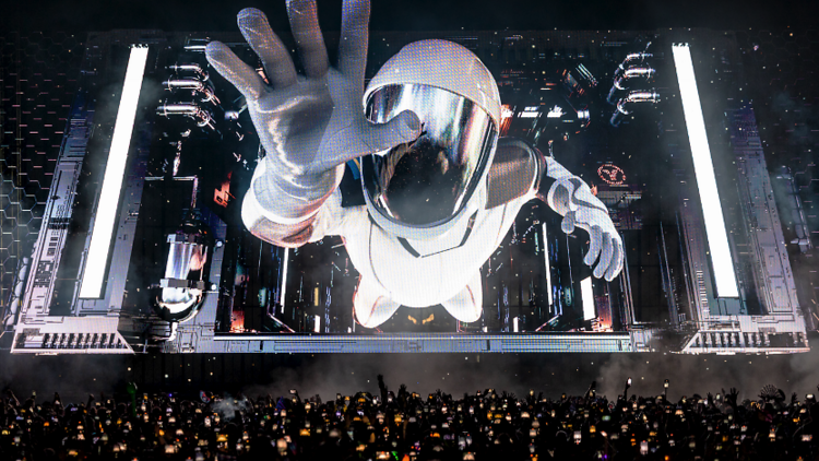 holographic astronaut coming out of the screen at a concert