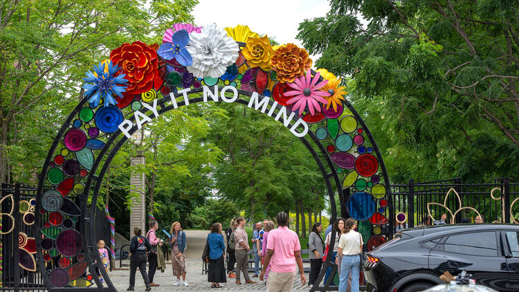 Walk beneath a floral gateway honoring an LGBTQ+ trailblazer