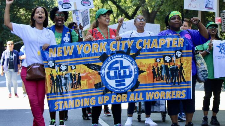 A group of people march in the Labor Day parade.