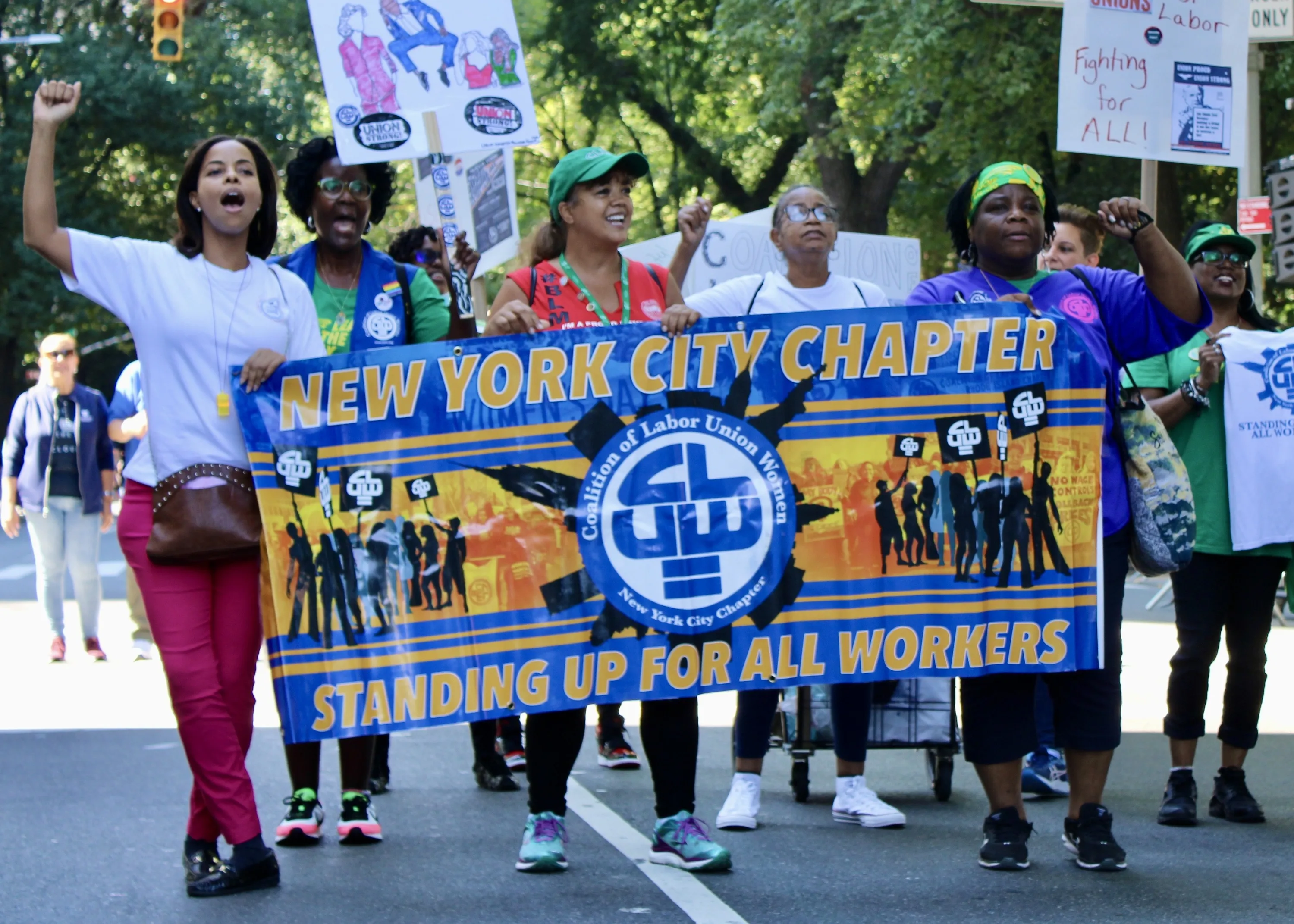 A group of people march in the Labor Day parade.