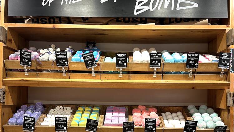 A row of bath bombs with the sign "Inventors of the Bath Bomb"