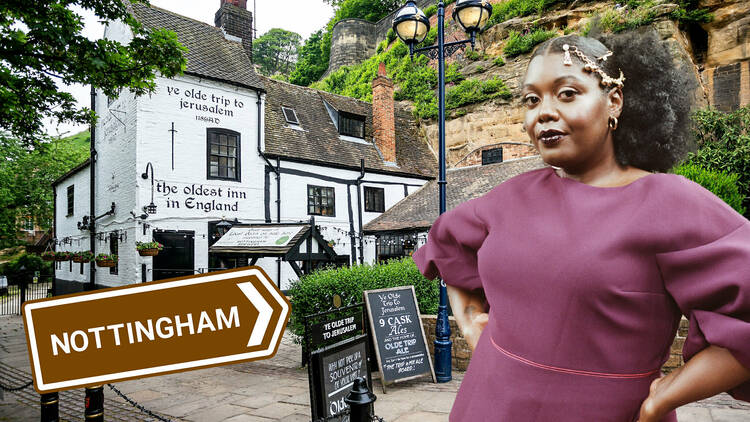 A woman standing in front of an old inn