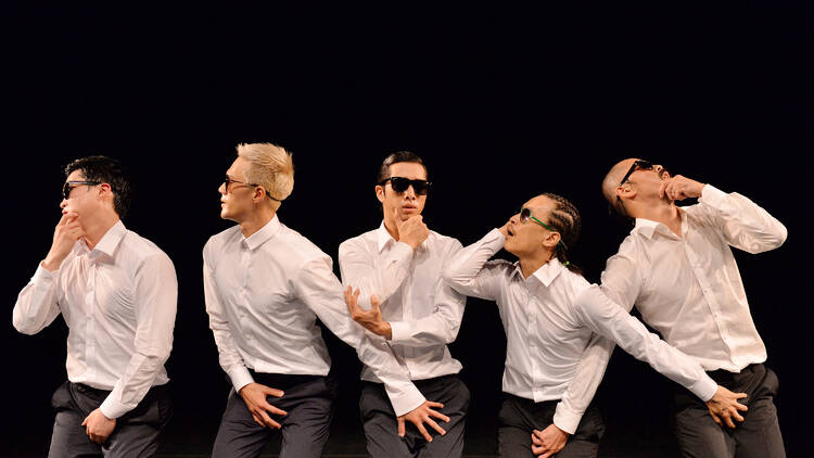 Five dancers wearing sunglasses and white shirts 