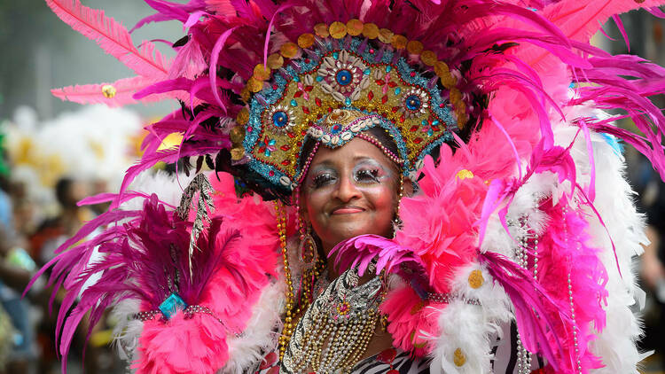 A woman in a pink costume at the West Indian Day Parade.