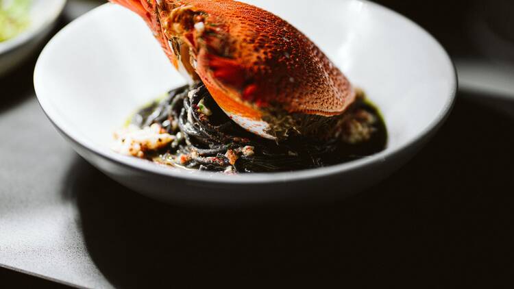 A bowl of squid ink pasta with spanner crab.
