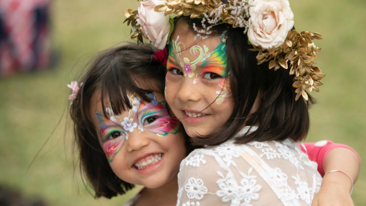 Two kids with face paint hugging