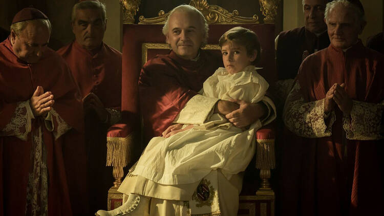 picture of a priest holding a little boy 