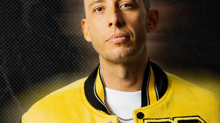 picture of the UK rapper Example in a yellow varsity jacket